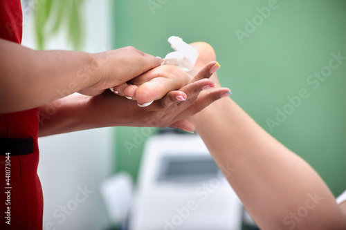 Wallpaper Mural woman applying cream on her foot Torontodigital.ca