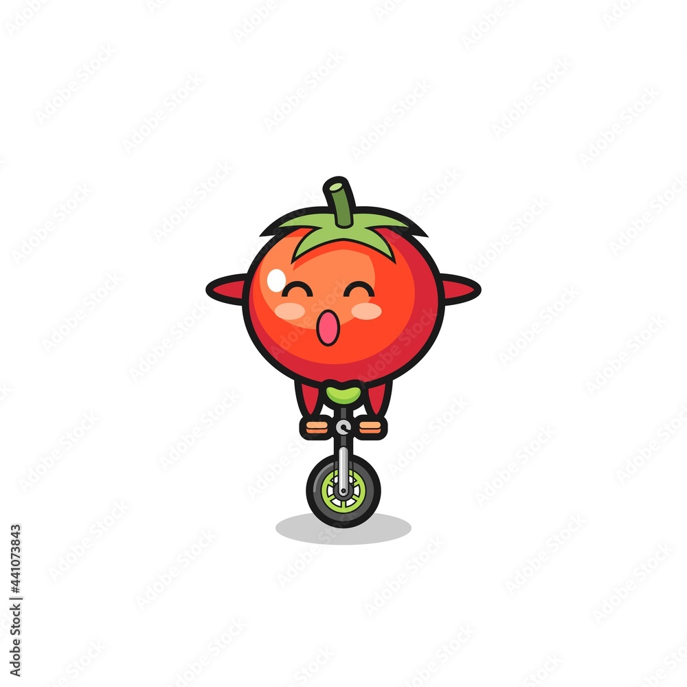 Obraz premium The cute tomatoes character is riding a circus bike