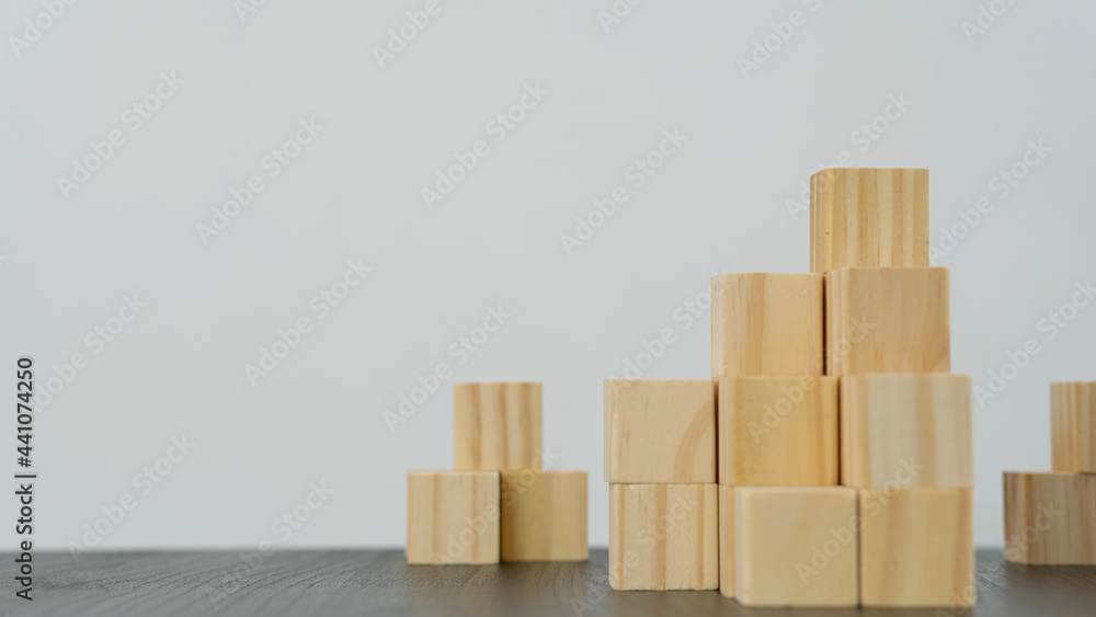 The wooden cubes are arranged in the shape of a pyramid on a white background table and can be put on your own message. business idea, The wooden cubes are arranged in the shape of a pyramid on a white background table and can be put on your own message. business idea,