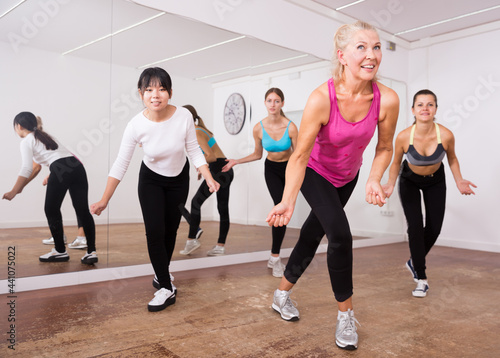 Fitness women practicing zumba movements
