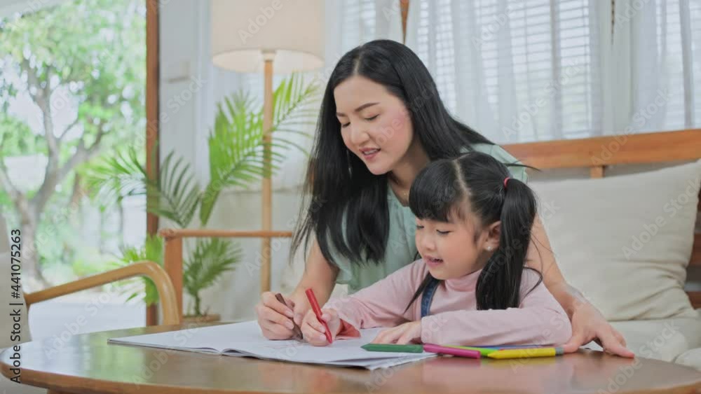 Asian little girl painting picture with mother in the living room. Asian little girl painting picture with mother in the living room.