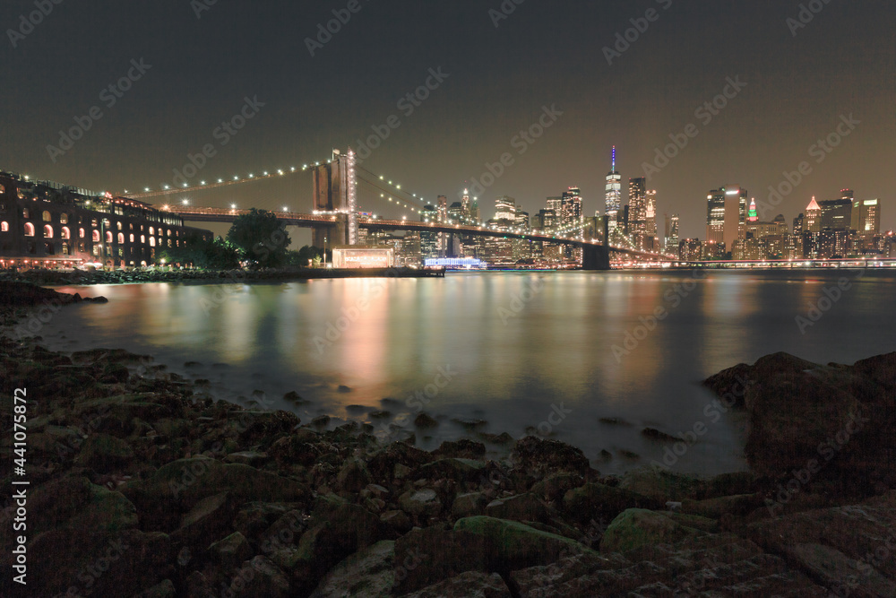 Brooklyn Bridge and New York City view at night on a hot summer day