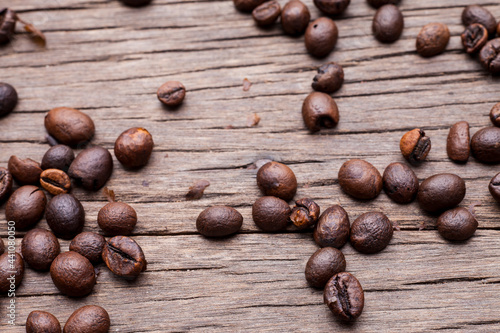 Coffee beans on old wooden floor background..