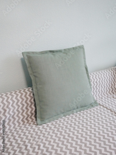 The interior of the room. The pillow is green on the sofa.  