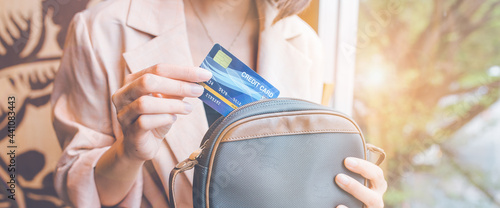 Obraz na płótnie Woman takes a credit card out of her pocket to make a purchase. w salonie