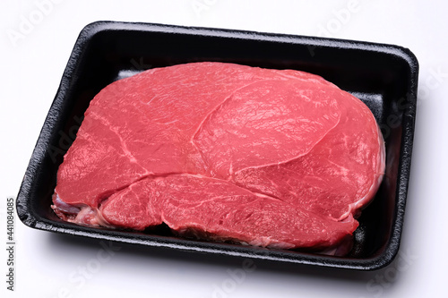 Canvas Print raw fresh beef knuckle steak cut in black tray isolated on white background