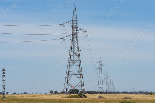 A row of electricity stanchions receding into the distance photo