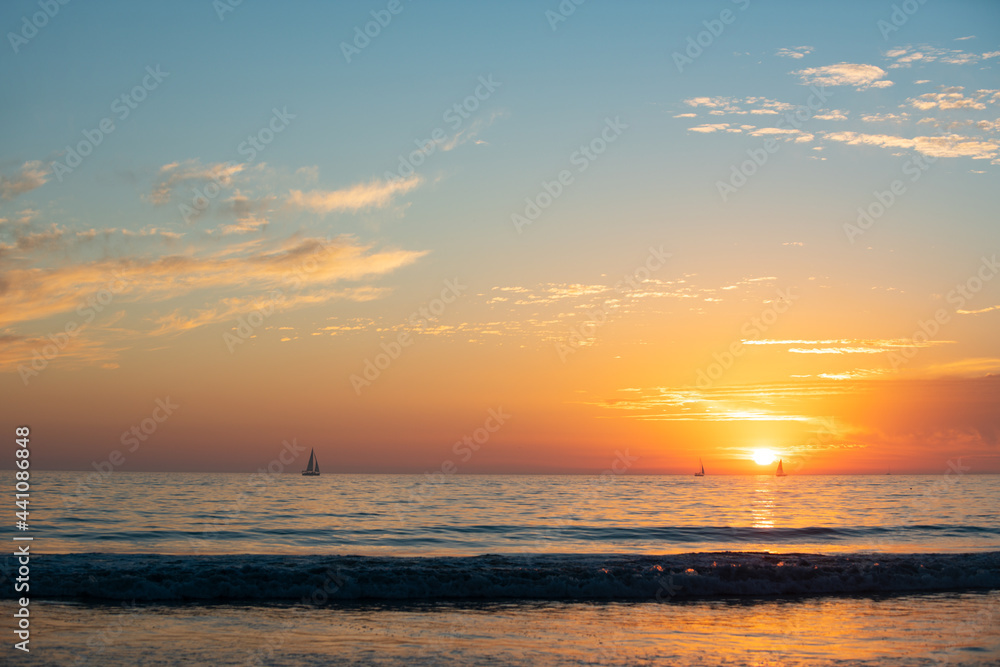 Panoramic view of sunset over ocean. Beautiful serene scene. Sea sky concept, sunrise colors clouds. Nature landscape, scenery beach. Summer vacation background.