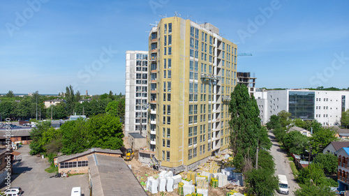 Building external wall thermal insulation with mineral wool. Exterior passive house wall heat insulation with mineral wool. Insulation the facade of commercial building. Energy efficiency