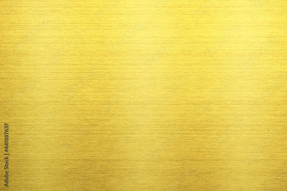 Shiny gold polished metal background texture of brushed stainless steel plate with the reflection of light. Shiny gold polished metal background texture of brushed stainless steel plate with the reflection of light.