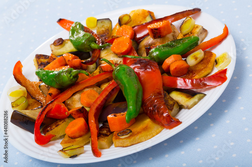 Top view of tasty baked vegetables at plate, healthy vegetarian food