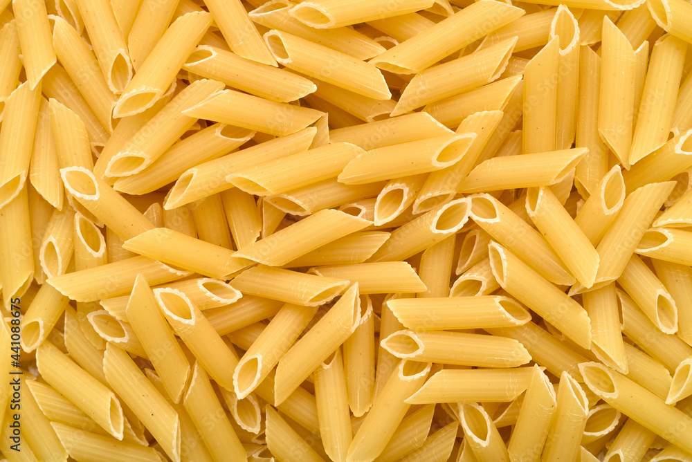 Close-up of uncooked penne pasta. Top view. Close-up of uncooked penne pasta. Top view.
