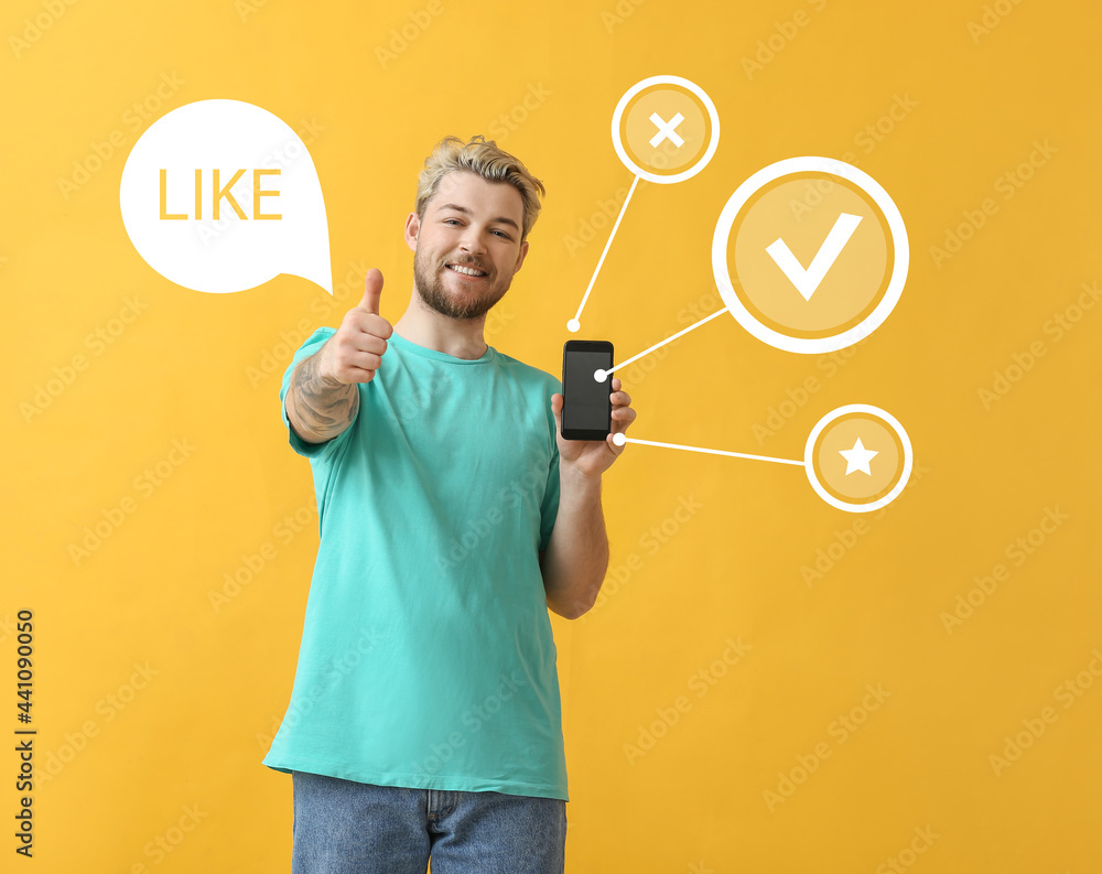 Young man giving high rating to new mobile application on color background Young man giving high rating to new mobile application on color background