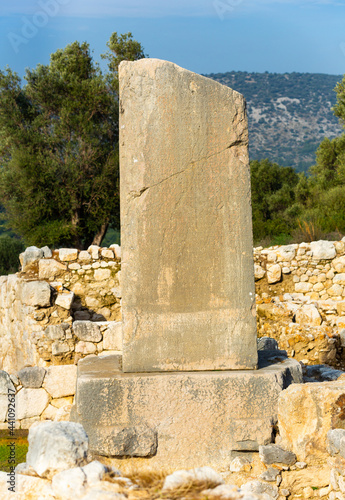 Remained Xanthian Obelisk or Xanthus Stele, stone pillar with inscriptions in Lycian and Greek in ancient city of Xanthos near modern town of Kinik, Turkey photo