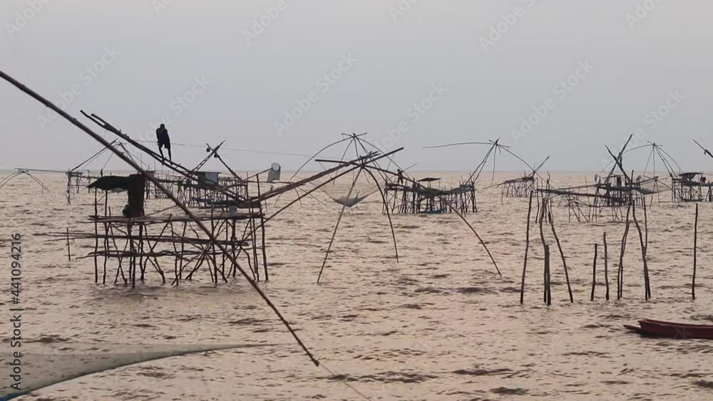 fishermen catch fish with large nets, before sunrise, southern thailand fishermen catch fish with large nets, before sunrise, southern thailand