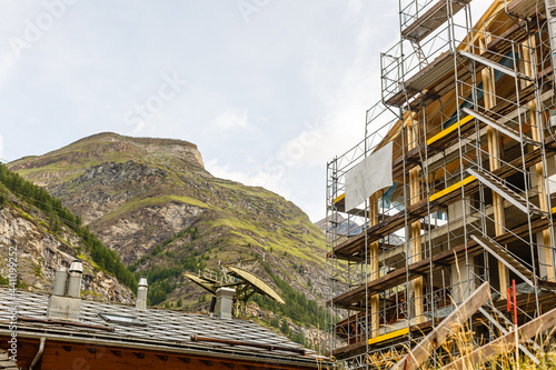 New construction of high-rise buildings construction site in the center of the city against the backdrop of a mountain ridge