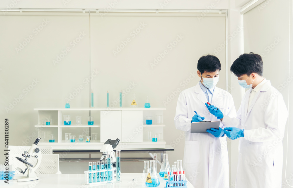 Two asian scientist team reserch chemistry science tube experiment biotech antibody sample in laboratory Cultivate Vaccine against covid-19 virus. Scientist consult, analyze in Chemistry Laboratory Two asian scientist team reserch chemistry science tube experiment biotech antibody sample in laboratory Cultivate Vaccine against covid-19 virus. Scientist consult, analyze in Chemistry Laboratory