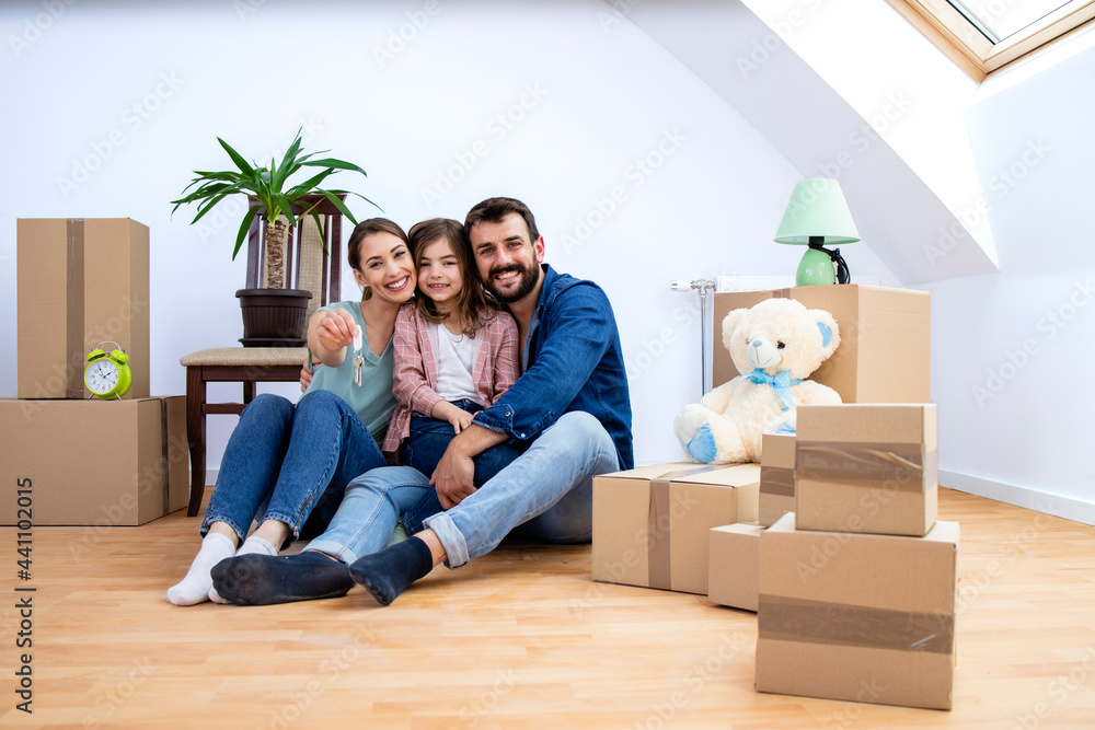 Portrait of happy young family enjoying their new house.