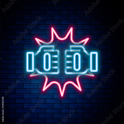 Glowing neon line Punch in boxing gloves icon isolated on brick wall background. Boxing gloves hitting together with explosive. Colorful outline concept. Vector