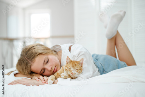 Girl with a cat. A child with a pet at home. High quality photo
