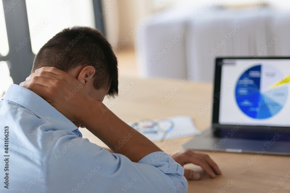 Fototapeta premium Emotional stress, bankruptcy, depressed businessman going through bankruptcy sitting in the office in front of laptop with bad report, economic trouble and failure concept
