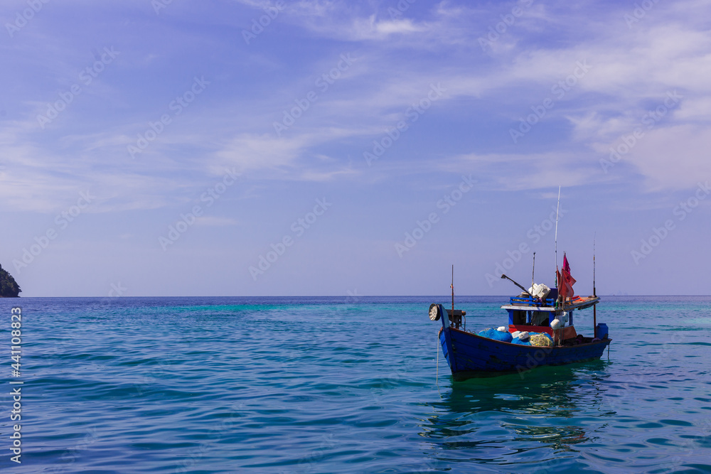 fishing boat on the sea near island with blue sky on sunny day fishing boat on the sea near island with blue sky on sunny day