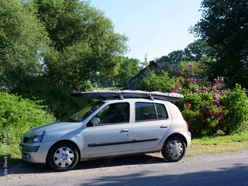 A car with a surfboard. France.