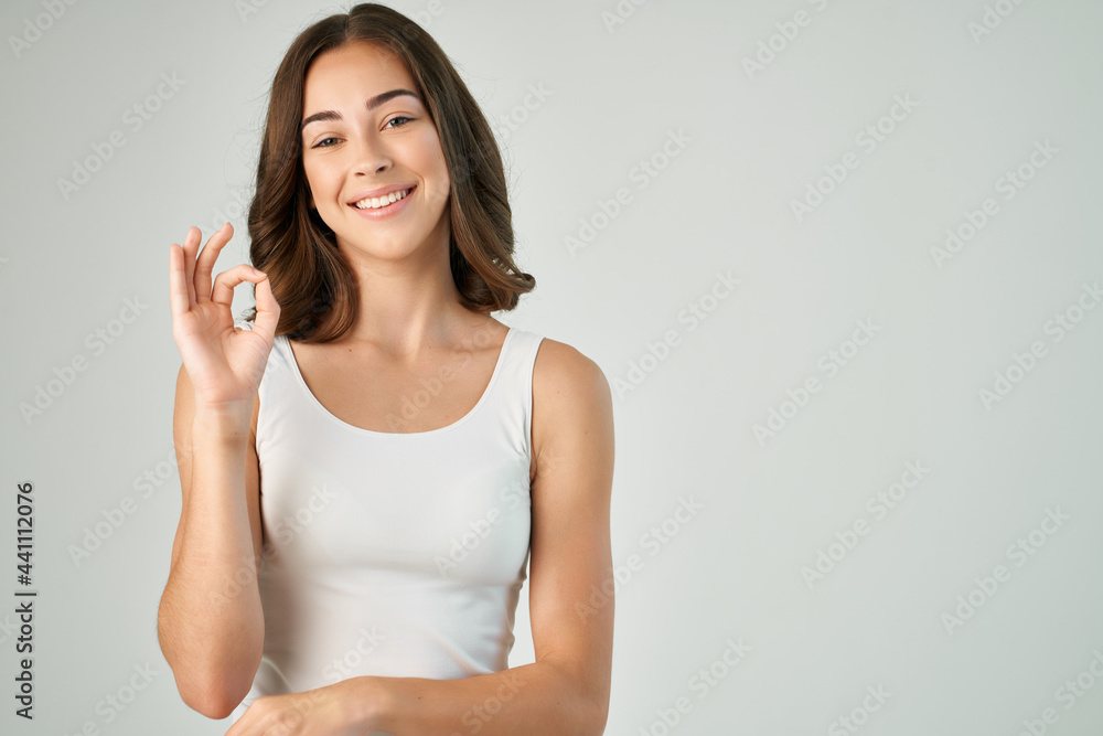 brunette with a fashionable hairstyle holding her hair emotions white t-shirt surprise brunette with a fashionable hairstyle holding her hair emotions white t-shirt surprise