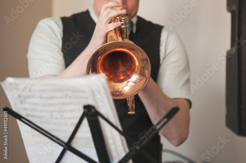 Trumpet in musician hands. Close up photo