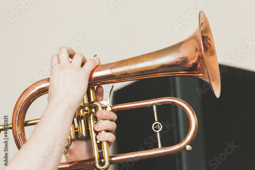 Flugel horn in hands, close-up photo photo
