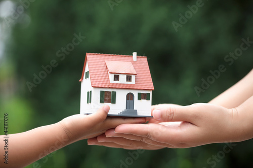 Parents handed the house model to the child