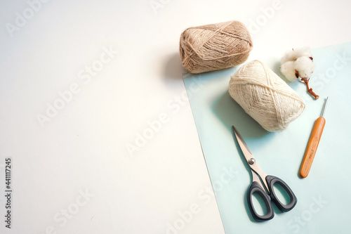 Yarn balls and materials for handmade crochet on white background