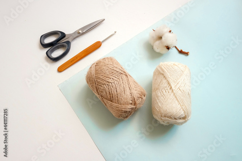 Yarn balls and materials for handmade crochet on white background