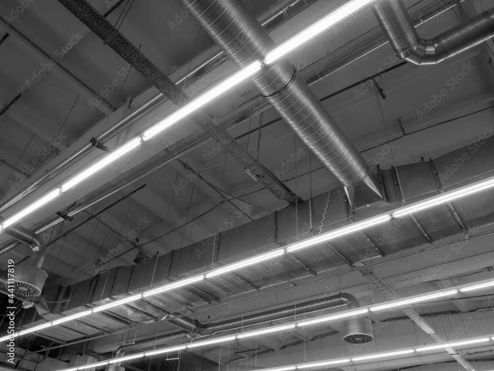 Ventilation system in industrial and commercial premises under the ceiling, with lighting, monochrome. Ventilation system in industrial and commercial premises under the ceiling, with lighting, monochrome.