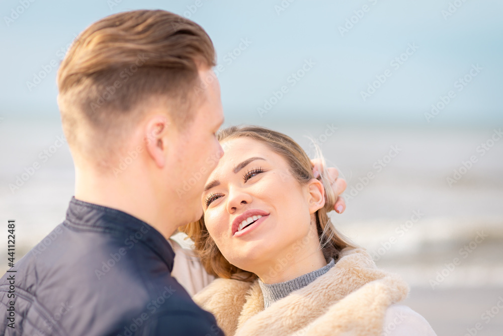 Two Young couple standing enjoying on a coast and enjoying each other.Summer,spring,autumn vacation.Closeup. Two Young couple standing enjoying on a coast and enjoying each other.Summer,spring,autumn vacation.Closeup.