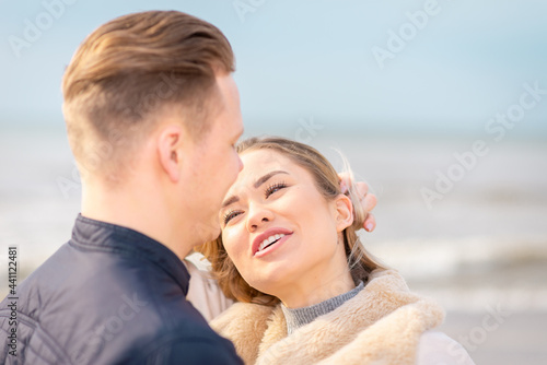 Two Young couple standing enjoying on a coast and enjoying each other.Summer,spring,autumn vacation.Closeup.