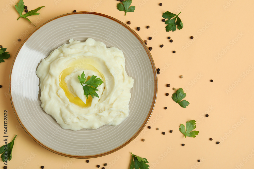 Plate of mashed potatoes and spices on beige background Plate of mashed potatoes and spices on beige background