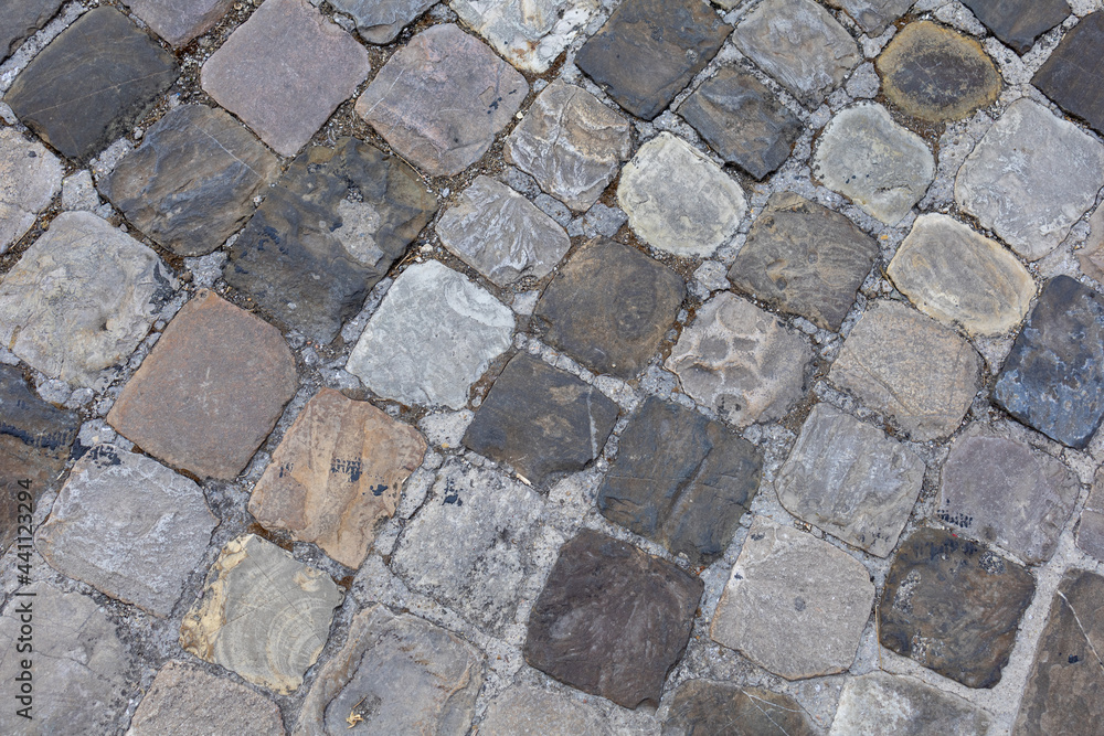 Obraz premium lose up shot of an historical, heritage paved road in a medieval burg in Italy called Sant'Arcangelo di Romagna. Road made with small square shiny stones called SANPIETRINI.