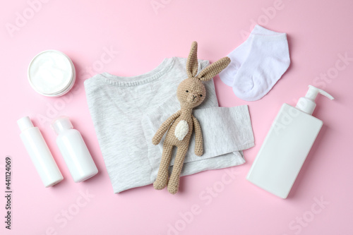 Different baby hygiene accessories on pink background