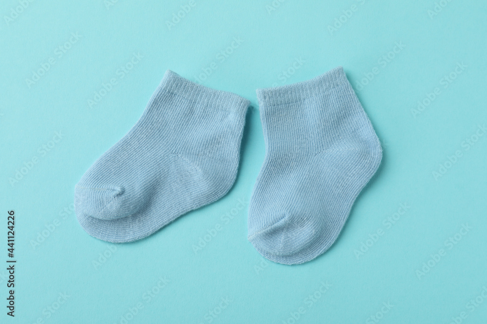 Pair of cute baby socks on blue background Pair of cute baby socks on blue background