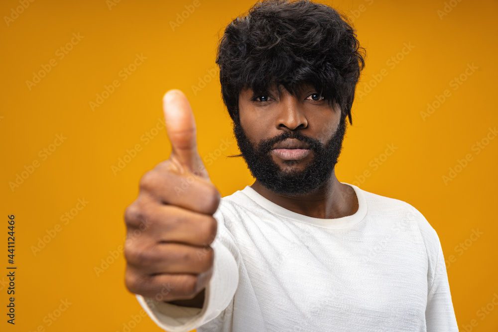 Happy young black man giving thumbs up Happy young black man giving thumbs up