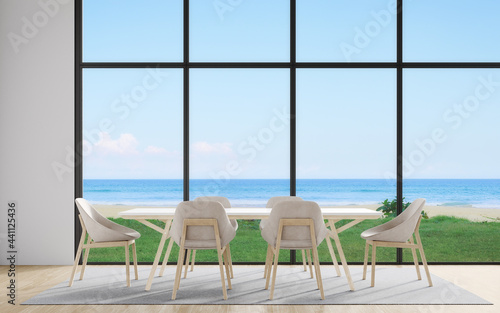 Dining table with chair set and carpet on wooden floor of large dining room in modern house or luxury hotel. Minimal home interior 3d rendering with sky and sea view.