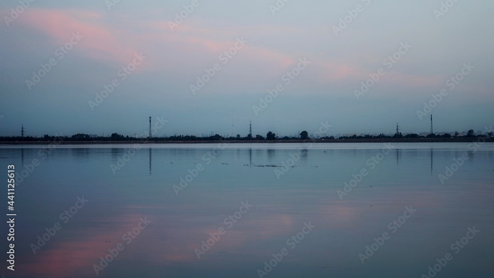 Fototapeta premium evening over the river. evening by the lake. evening sky by the river.
