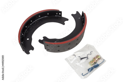 drilled brake pads with truck brake pads on an isolated white background. A set of two parts. With repair kit