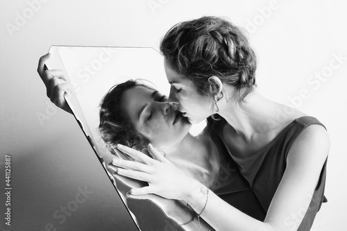 Portrait of the woman with mirror reflection, studio