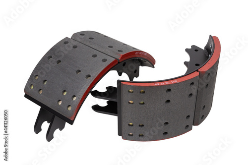 drilled brake pads with truck brake pads on an isolated white background. A two-part set