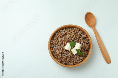 Concept of tasty eating with buckwheat on white background