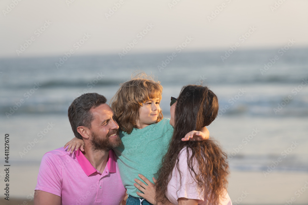 happy family portrait of mother father and son kid on miami beach in summer vacation, family