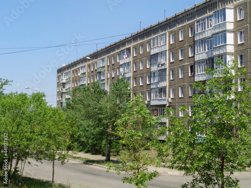 Soviet architecture. Ust-Kamenogorsk (Kazakhstan) Apartment buildings. Soviet architectural style. Residential buildings. Soviet built multistory apartment buildings. Old residential area. Green trees