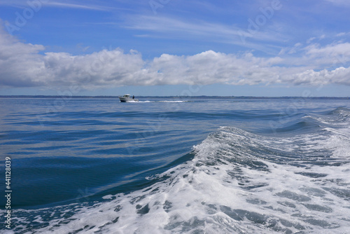 En bateau sur vagues d'écume en région Bretagne, France © didier salou